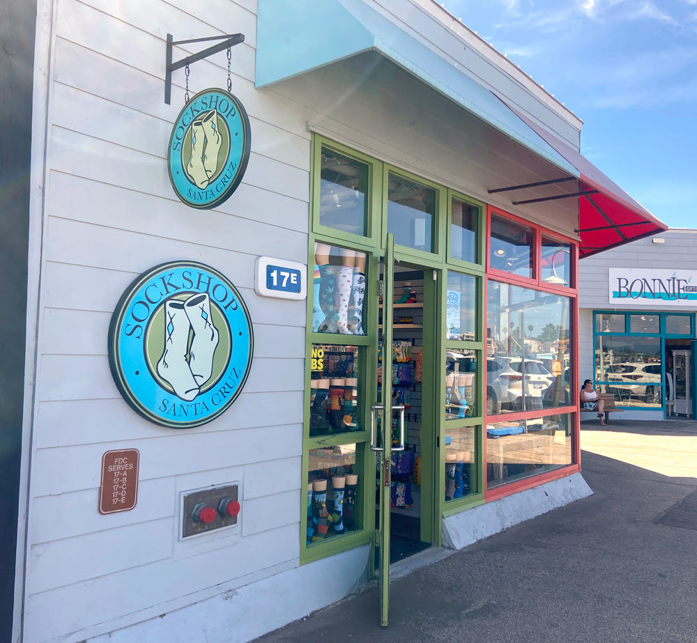 Storefront with 'Sockshop' sign and colorful glass doors.